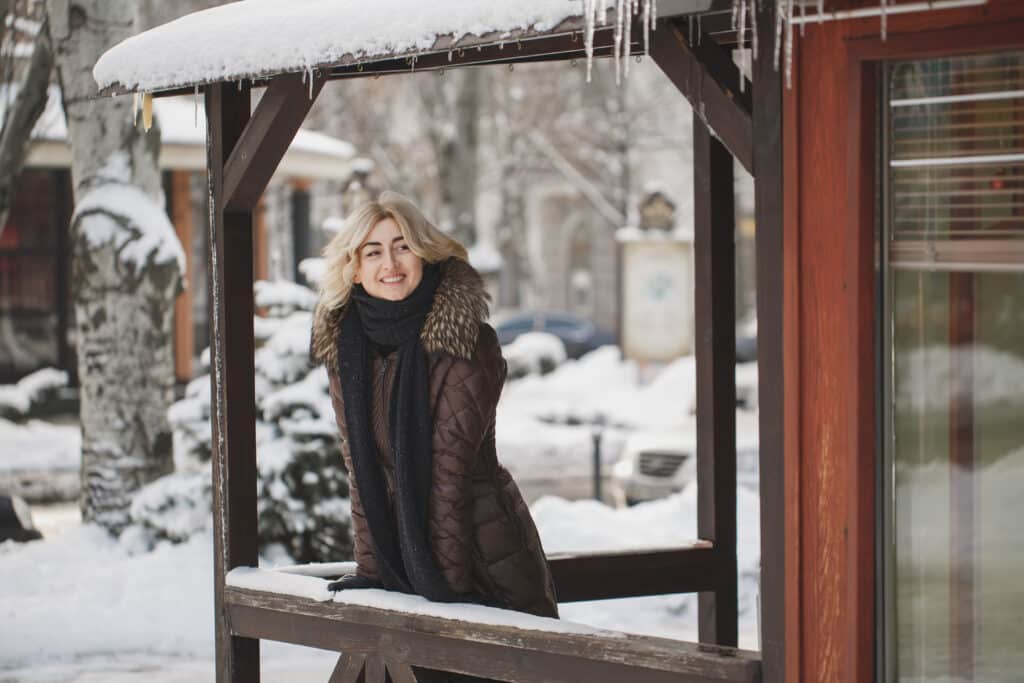 Beautiful woman posing in winter time in the city
