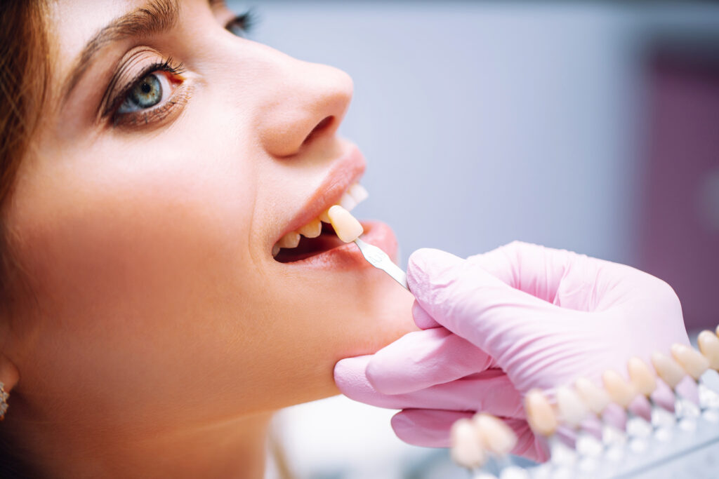 Young woman at the dentist's chair during a dental procedure. Overview of dental caries prevention.