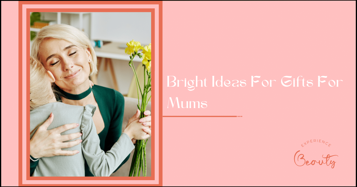 Bright Ideas For Gifts For Mums - Portrait of blonde young woman embracing little daughter and smiling holding flowers on Mothers day at home