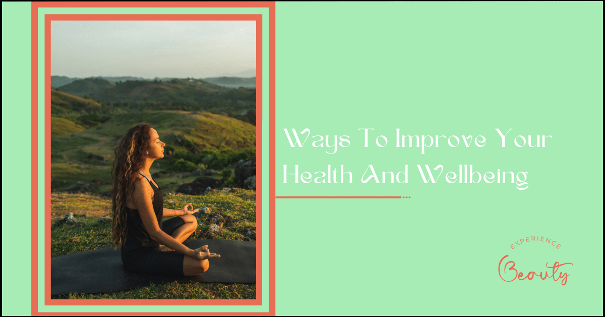 Ways To Improve Your Health And Wellbeing Banner Image - Woman doing yoga alone at sunrise with mountain and ocean view